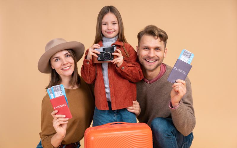 Happy family with passports and suitcase ready to travel