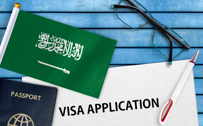 Visa application form and flag of Saudi Arabia