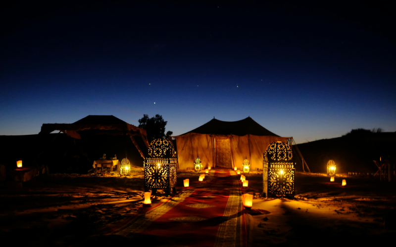 Desert camp setup with traditional lanterns glowing at night in Saudi Arabia