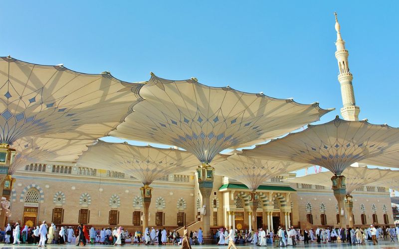 Courtyard of Prophet’s Mosque in Medina with large umbrellas and pilgrims