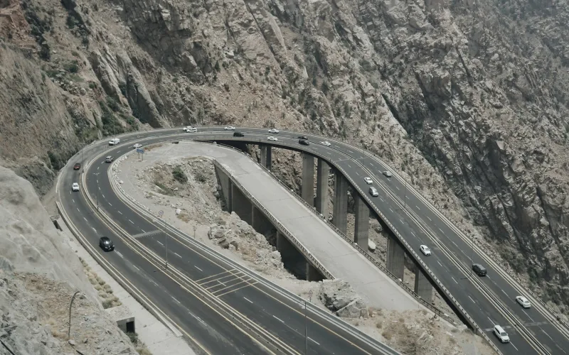 Curved mountain road in Taif, Saudi Arabia, surrounded by rocky terrain