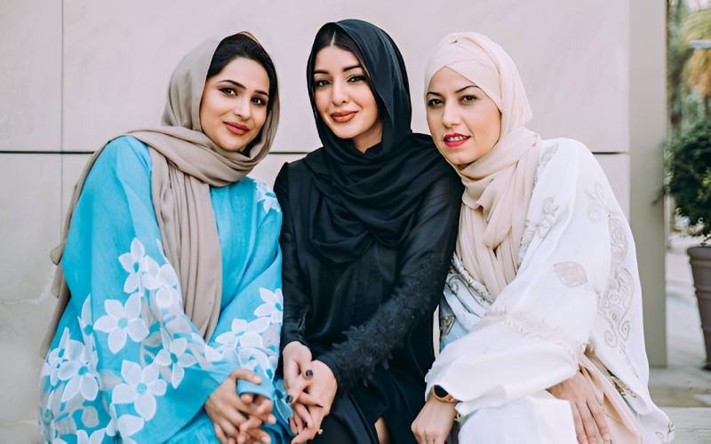 Three women wearing modest traditional clothing in Saudi Arabia