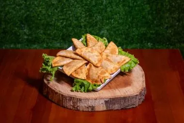 Turkish street food Lahmacun topped with fresh herbs and lemon